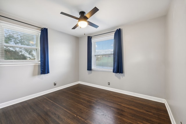 empty room featuring ceiling fan and dark hardwood / wood-style flooring