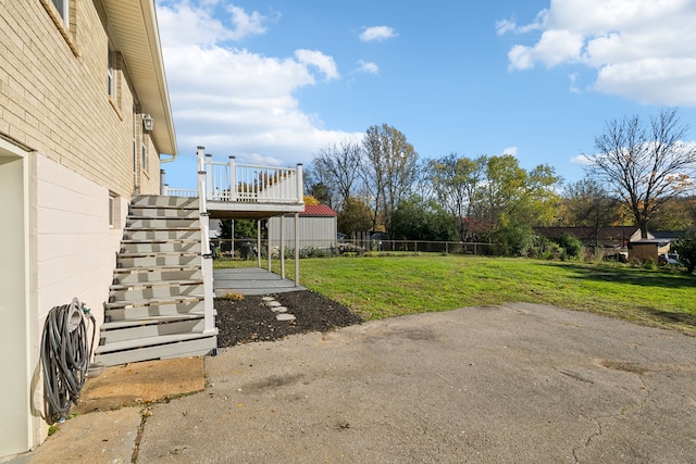 view of yard featuring a wooden deck and a patio area