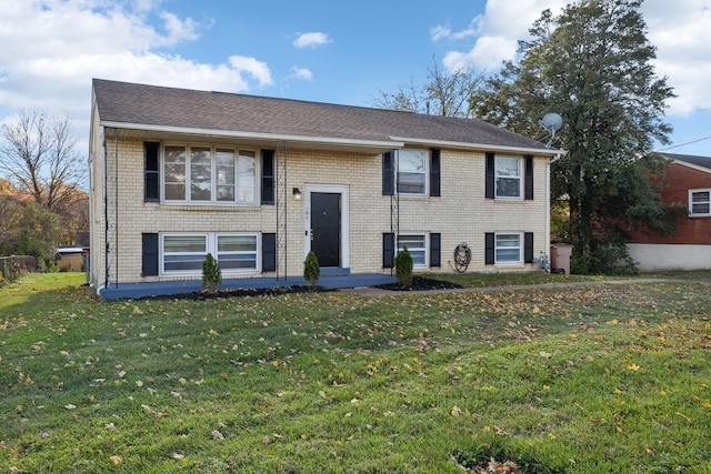 bi-level home with a front lawn