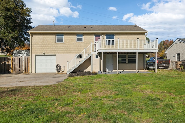 back of house with a patio, a yard, a garage, and a wooden deck