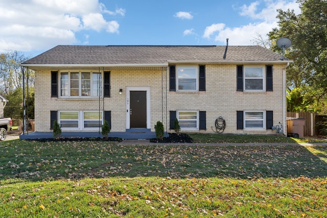 raised ranch featuring a front lawn