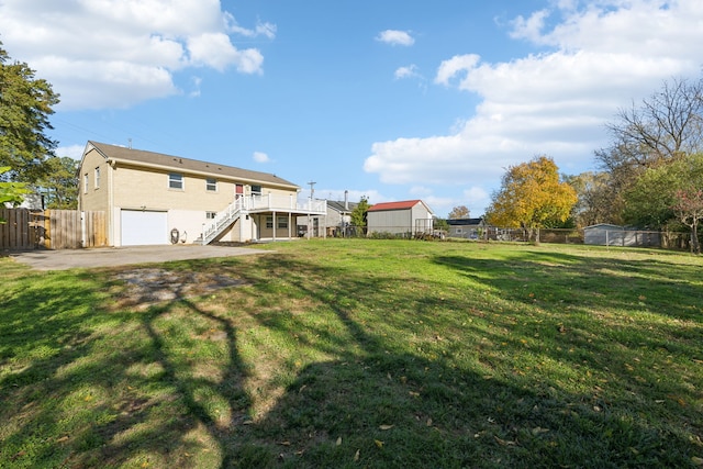 view of yard featuring a deck and a garage