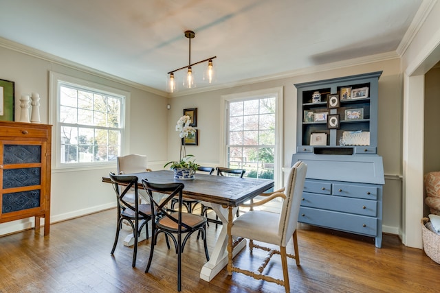 dining room featuring dark hardwood / wood-style floors and ornamental molding