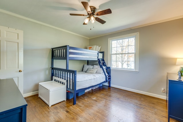 bedroom with wood-type flooring, ceiling fan, and ornamental molding