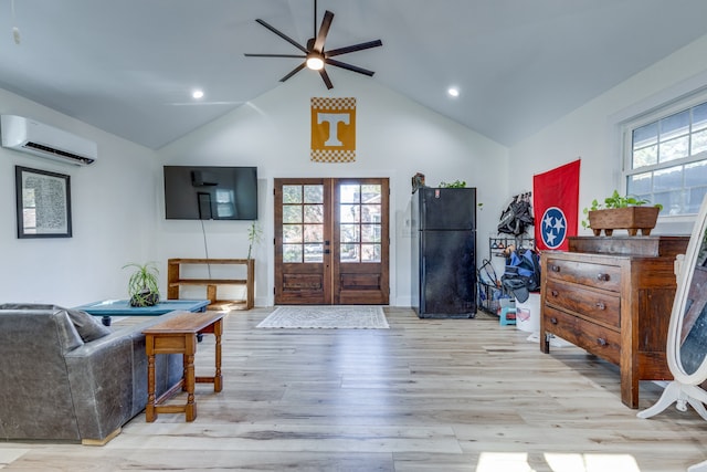 foyer featuring high vaulted ceiling, french doors, an AC wall unit, ceiling fan, and light hardwood / wood-style floors