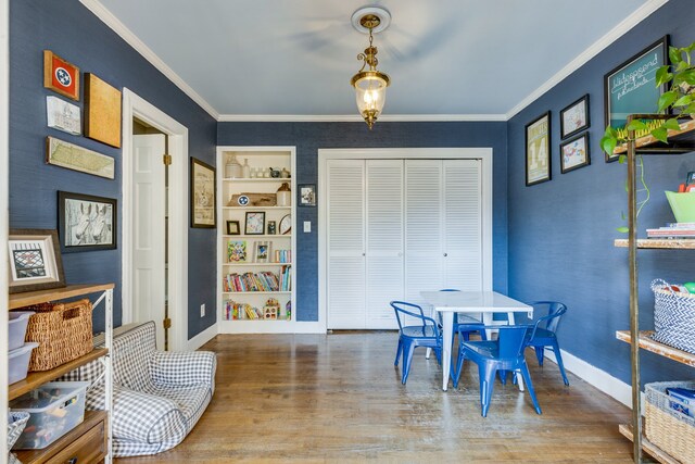 dining area with crown molding and hardwood / wood-style floors