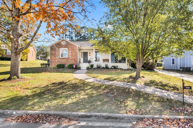 view of front of house with a porch and a front lawn