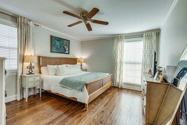 bedroom with hardwood / wood-style floors, ceiling fan, and crown molding