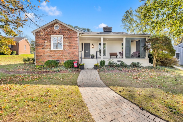 bungalow with a porch and a front yard