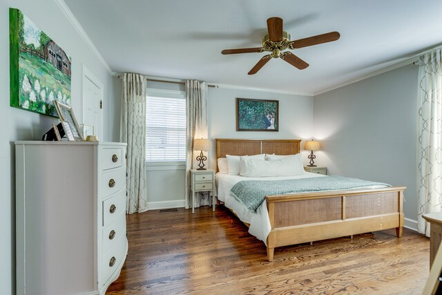 bedroom featuring hardwood / wood-style flooring, ceiling fan, and ornamental molding