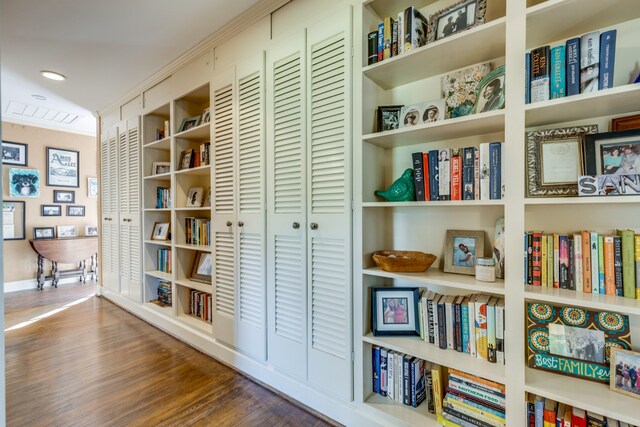 hallway featuring crown molding and dark wood-type flooring