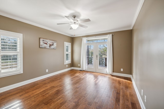 spare room featuring hardwood / wood-style floors, crown molding, french doors, and a healthy amount of sunlight