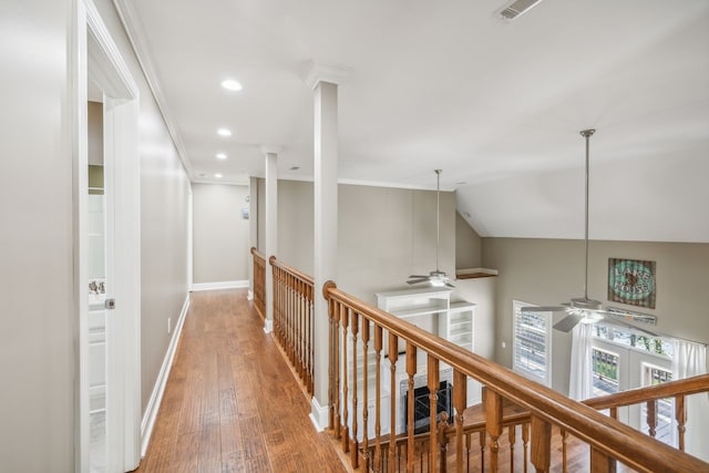 hallway with hardwood / wood-style flooring, ornamental molding, french doors, and vaulted ceiling