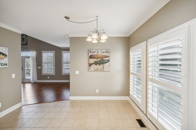 unfurnished dining area with light wood-type flooring, ornamental molding, and a chandelier