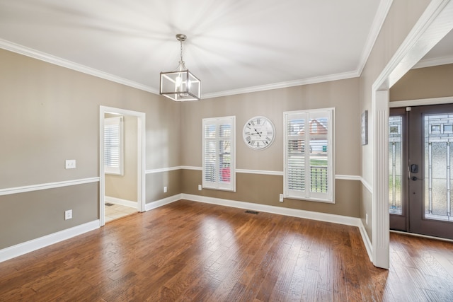 foyer entrance with a notable chandelier, crown molding, and dark wood-type flooring