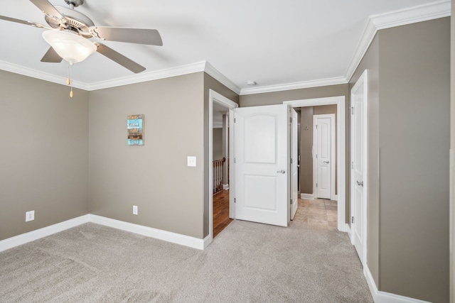 unfurnished bedroom with ceiling fan, ornamental molding, and light carpet