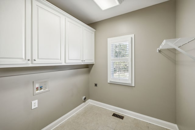 washroom featuring hookup for a washing machine, light tile patterned floors, cabinets, and hookup for an electric dryer