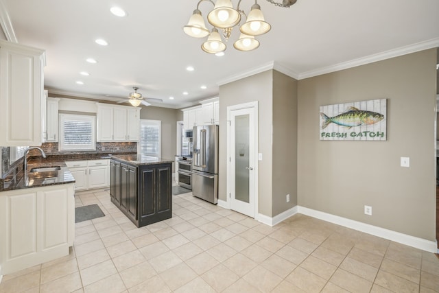 kitchen featuring backsplash, ornamental molding, stainless steel appliances, sink, and a kitchen island