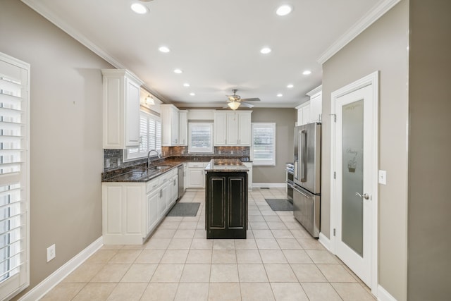 kitchen with white cabinetry, decorative backsplash, crown molding, and stainless steel appliances