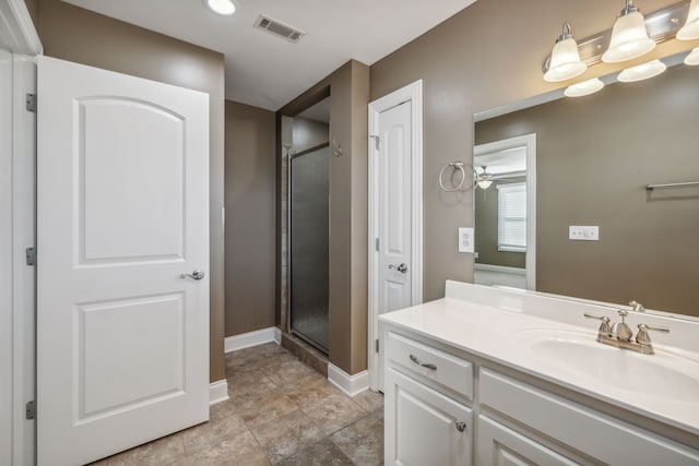 bathroom with vanity, a shower with door, and ceiling fan