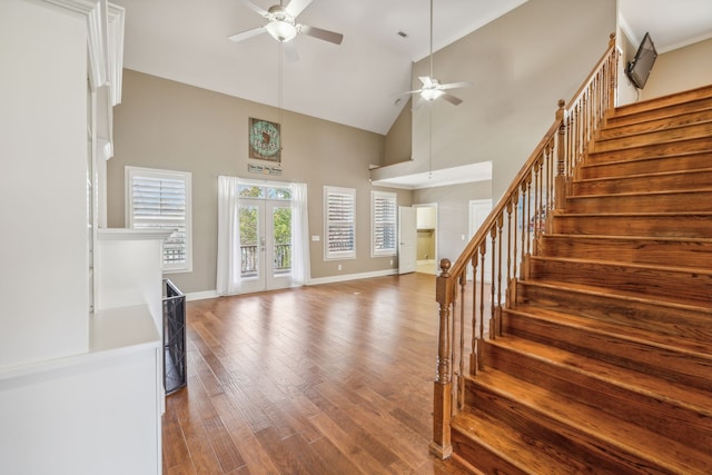 foyer entrance featuring ceiling fan, wood-type flooring, and high vaulted ceiling