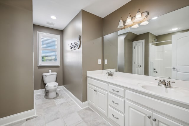 bathroom with vanity, toilet, and walk in shower