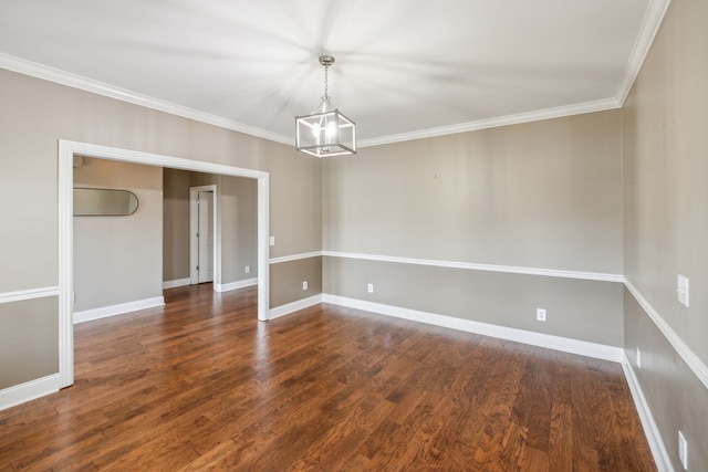 empty room with a chandelier, dark hardwood / wood-style flooring, and ornamental molding