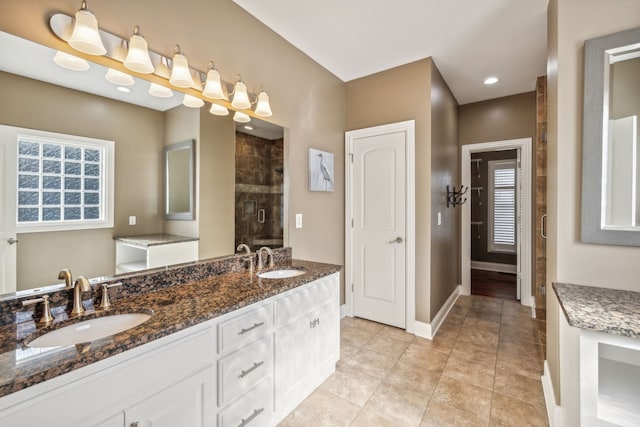 bathroom featuring tile patterned flooring, vanity, and an enclosed shower