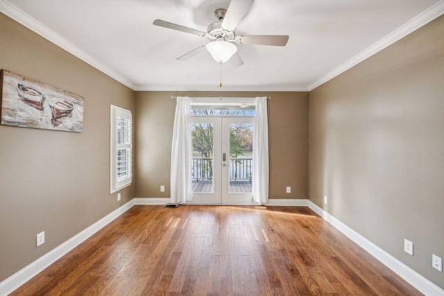 empty room with french doors, ceiling fan, crown molding, and hardwood / wood-style floors