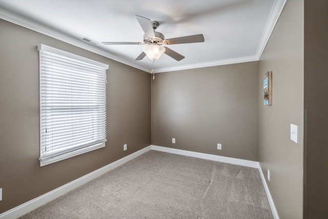 unfurnished room featuring ceiling fan, light colored carpet, and ornamental molding