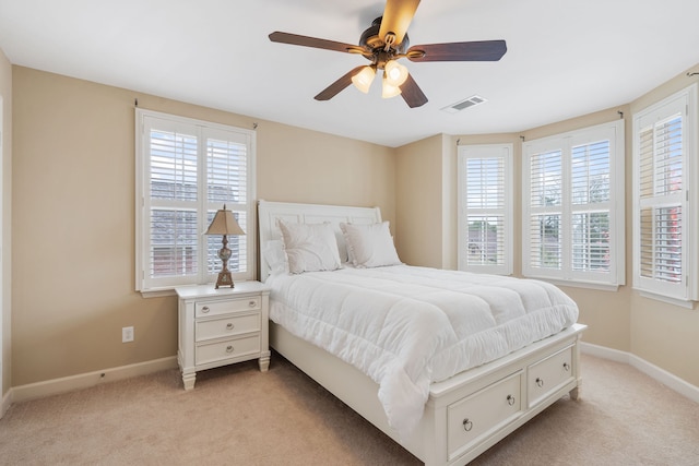 bedroom with ceiling fan and light colored carpet