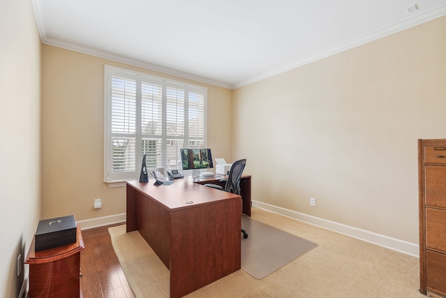 office space with light hardwood / wood-style floors and ornamental molding