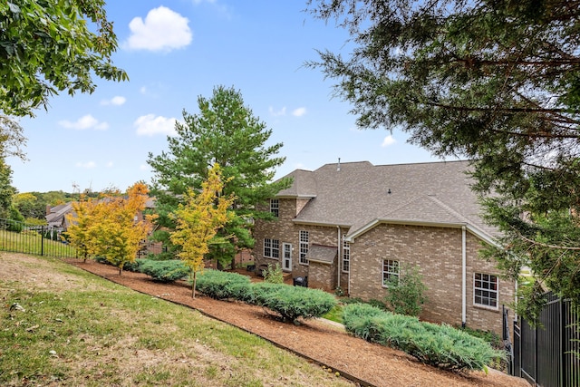 back of property with a lawn