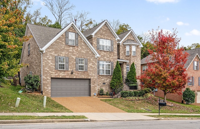 view of front of house featuring a front lawn and a garage