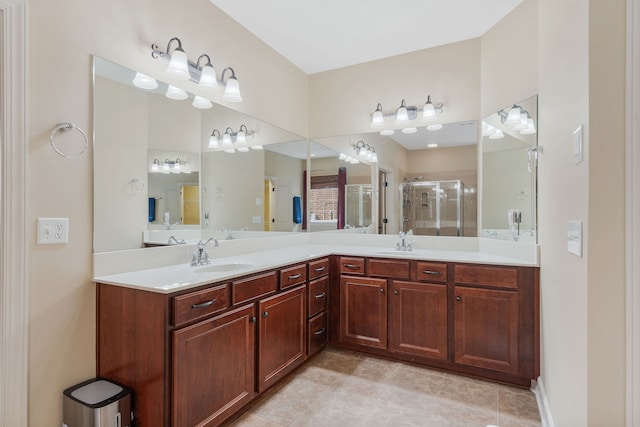 bathroom featuring a shower with door, vanity, and tile patterned flooring