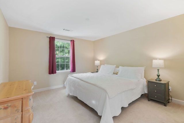 bedroom featuring light colored carpet