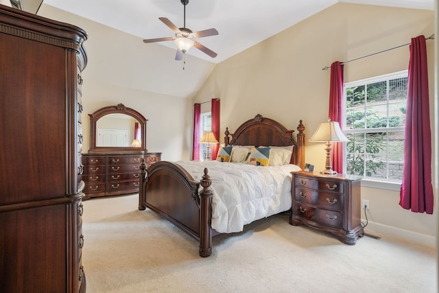 bedroom with ceiling fan, light colored carpet, and vaulted ceiling