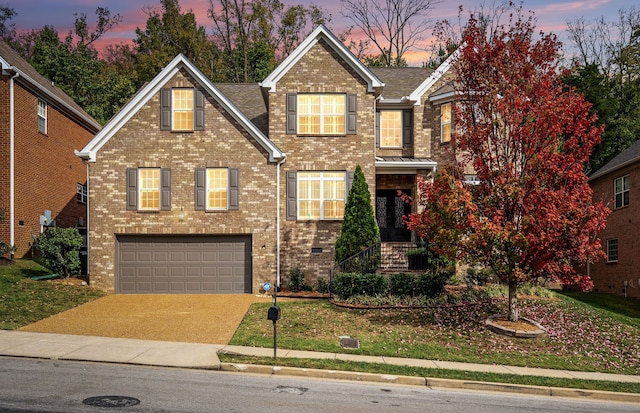 view of front facade featuring a garage and a lawn