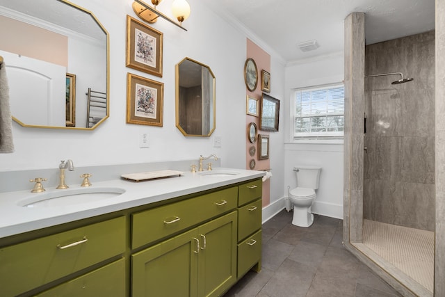 bathroom featuring ornamental molding, vanity, tiled shower, tile patterned flooring, and toilet