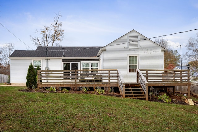 back of house with a lawn and a wooden deck