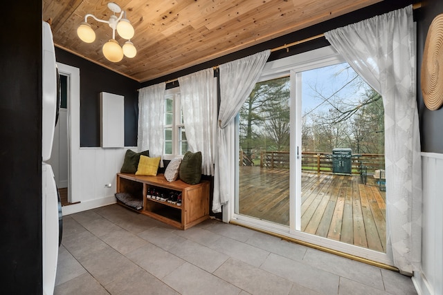 doorway to outside featuring wooden ceiling, light tile patterned floors, and a healthy amount of sunlight