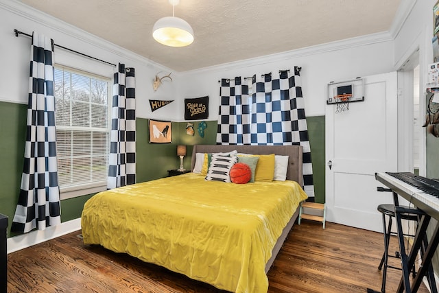 bedroom with dark wood-type flooring, a textured ceiling, and ornamental molding