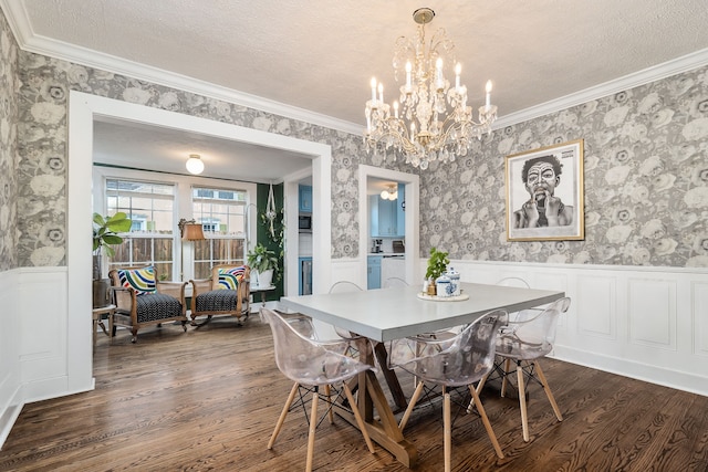 dining space with a textured ceiling, ornamental molding, and dark wood-type flooring