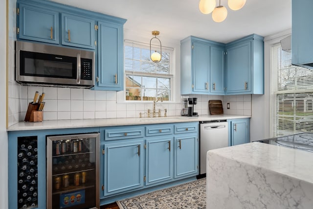 kitchen with appliances with stainless steel finishes and blue cabinets