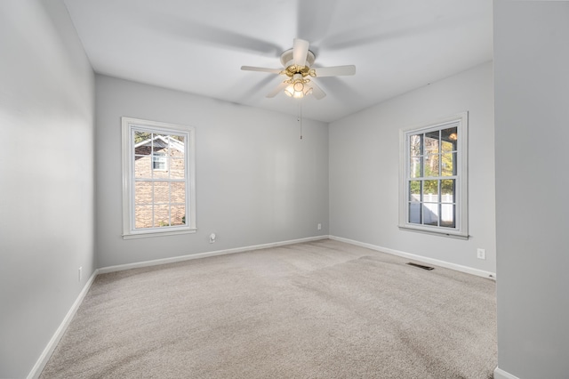 spare room featuring carpet flooring and ceiling fan