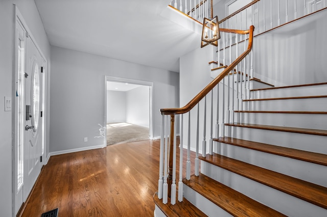 foyer entrance featuring a notable chandelier and hardwood / wood-style flooring