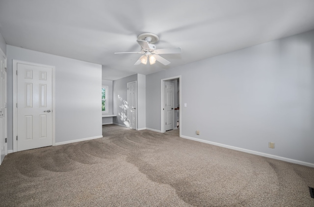 empty room with carpet and ceiling fan