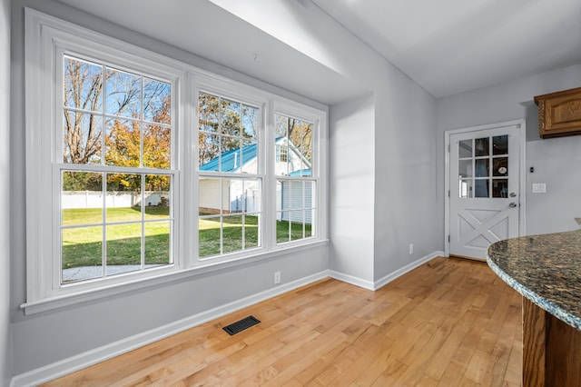 dining space featuring a wealth of natural light and light wood-type flooring