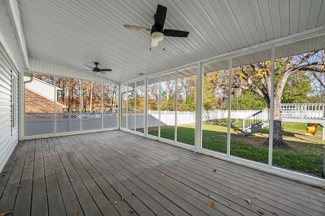 wooden deck featuring ceiling fan and a yard