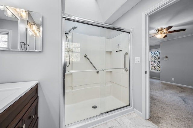 bathroom with vanity, ceiling fan, and an enclosed shower